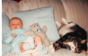 Patrick as a baby with his cat and teddy bear.
